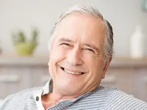 Portrait of senior man smiling at home